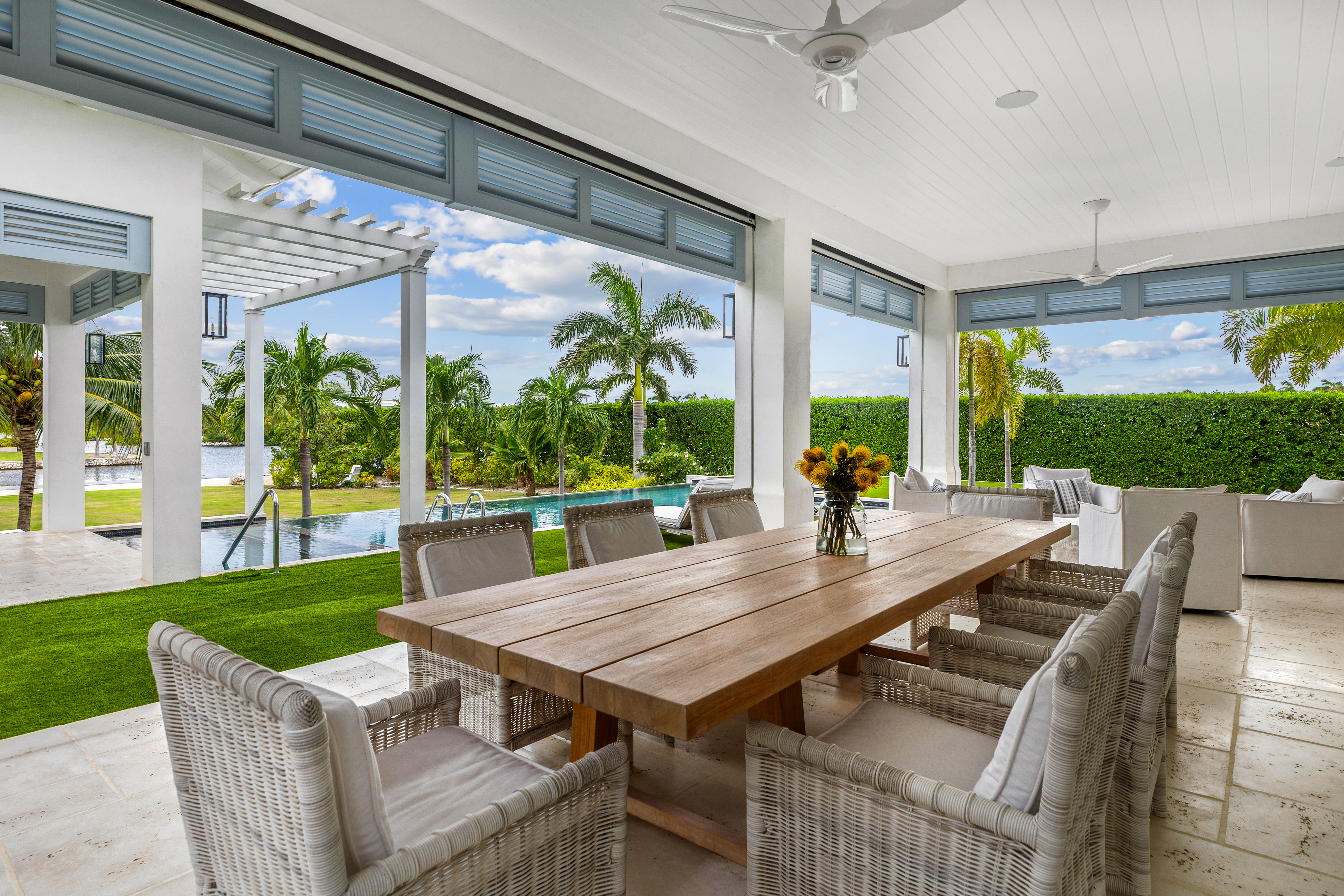 Eight seated table inside conservatory facing pool