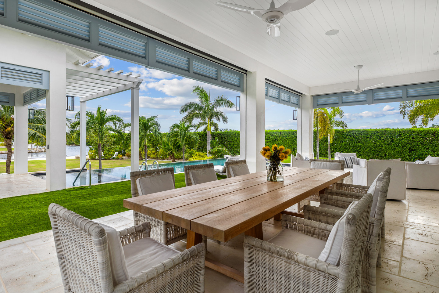 Eight seated table inside conservatory facing pool