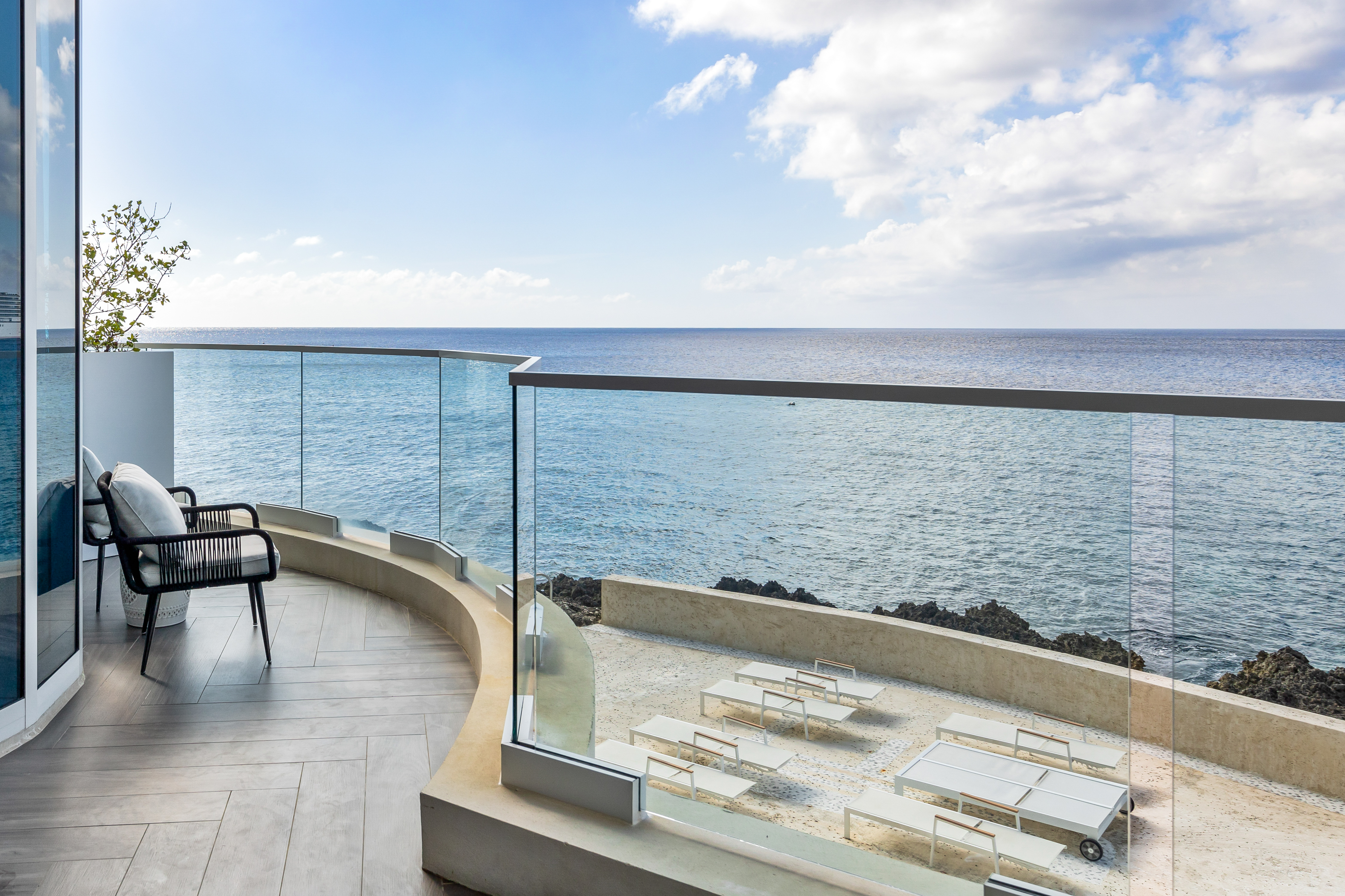 Balcony with chair on it with view of the sea 
